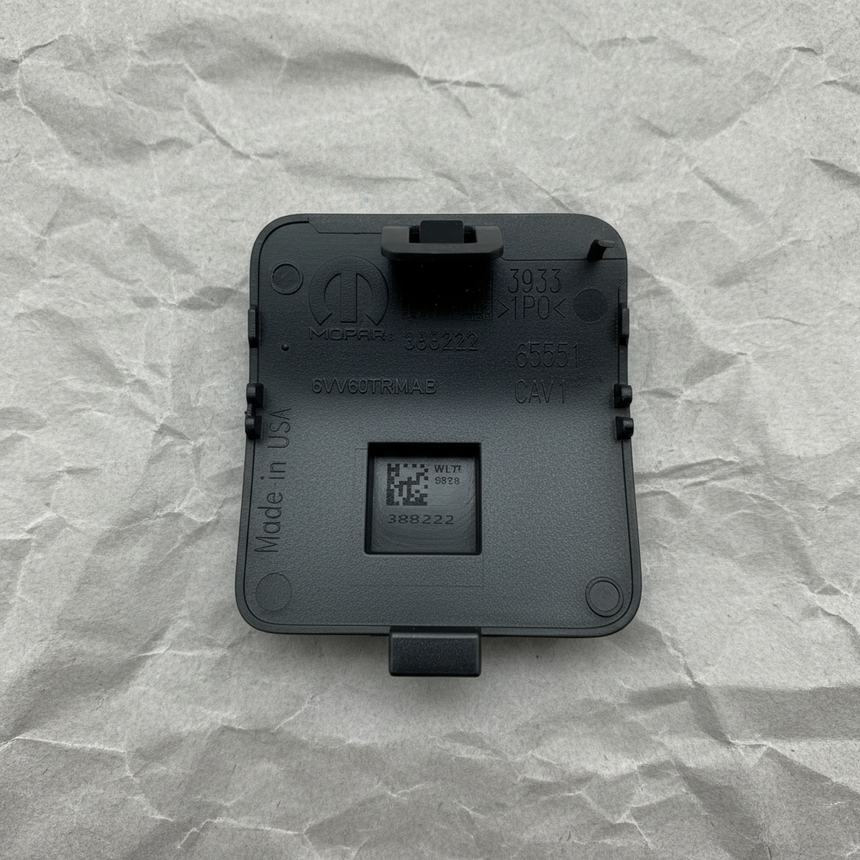 Close-up alternate angle of Mopar OEM Textured Front Tow Hook Cover for Grand Cherokee L
