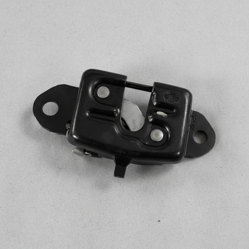 Upper-middle macro crop of rear gate latch on light grey wrinkled kraft paper