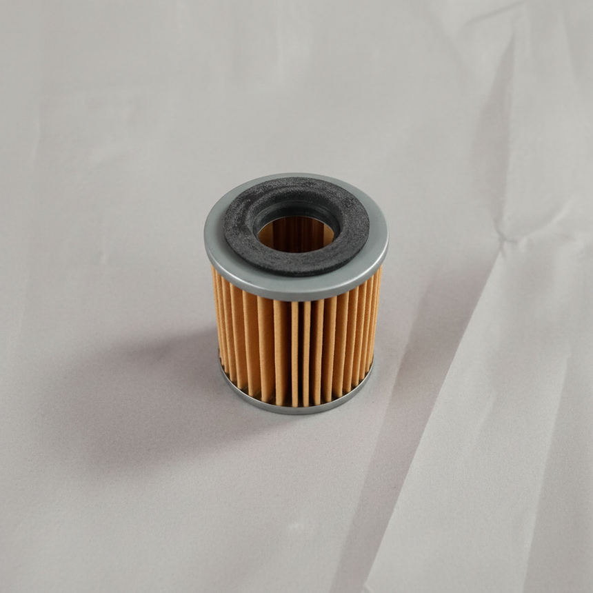 Transmission oil filter on grey wrinkled craft paper background