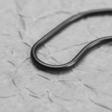 Lower-middle macro crop on light grey wrinkled kraft paper background