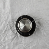 Full view of center control switch AWD on light grey wrinkled kraft paper