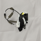 Full view of door lock actuator motor on light grey wrinkled kraft paper