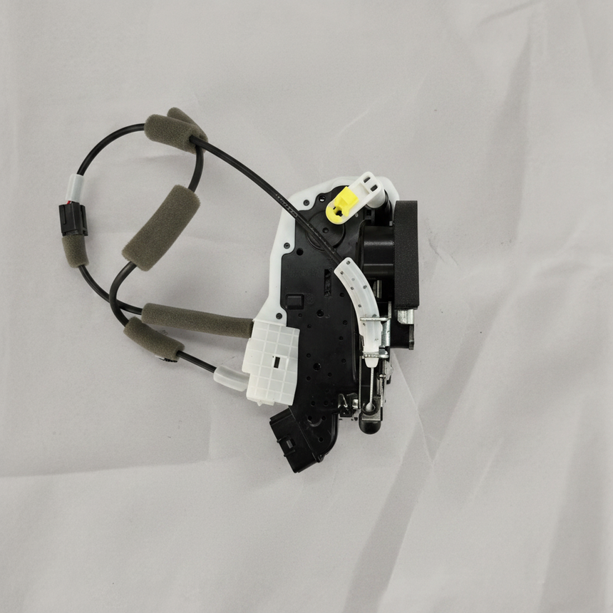 Full view of door lock actuator motor on light grey wrinkled kraft paper