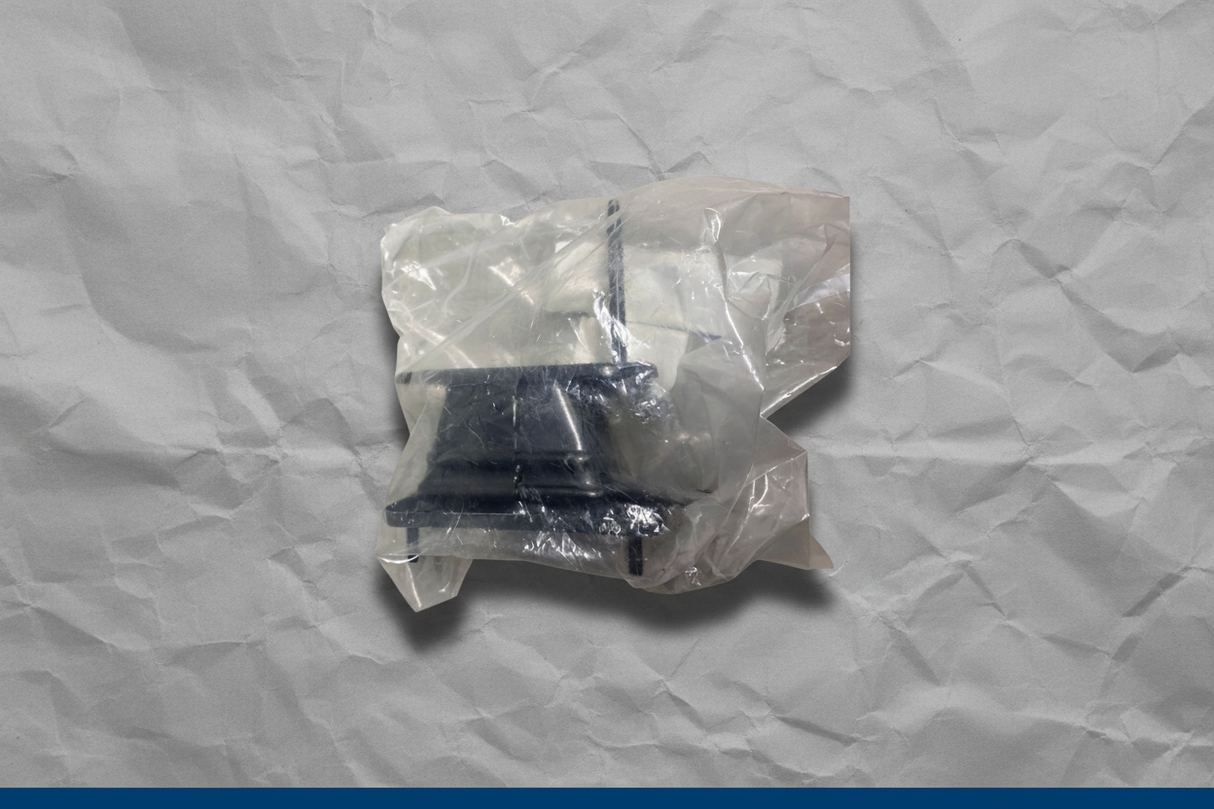 2021-2025 Kia Seltos FWD Rear Driver Side Bumper Stay Bracket OEM - Rotated 27 degrees on gray kraft paper background