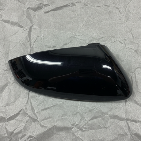 2023-2026 Prius Driver Side Genuine OEM Black Mirror Cover on grey kraft paper