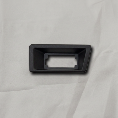 OEM License Plate Lamp Bezel on grey wrinkled craft paper background