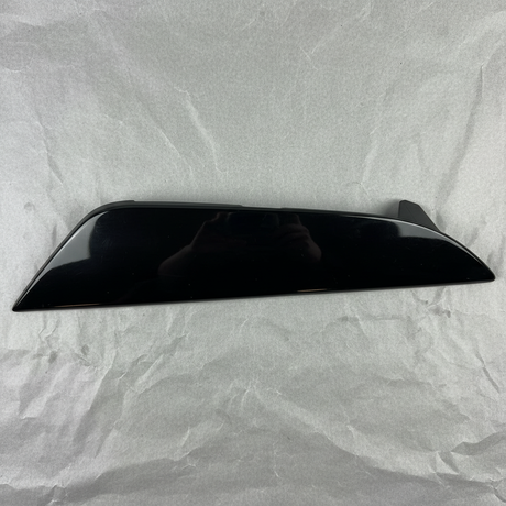 Close-up of Kia OEM Rear Driver Side Bumper Insert Glossy Black for 2021-24 K5