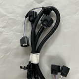 Top macro crop of rear park assist camera wiring harness on light grey wrinkled kraft paper