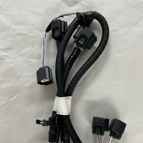 Top macro crop of rear park assist camera wiring harness on light grey wrinkled kraft paper