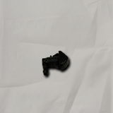 Acura MDX driver side front windshield washer nozzle on light grey wrinkled kraft paper background, packaging removed