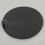 Bottom macro crop of Ford F-150 fuel tank filler door on light grey wrinkled kraft paper