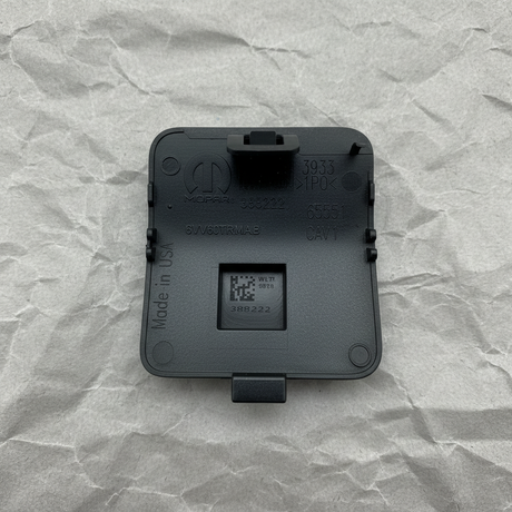 Close-up alternate angle of Mopar OEM Textured Front Tow Hook Cover for Grand Cherokee L