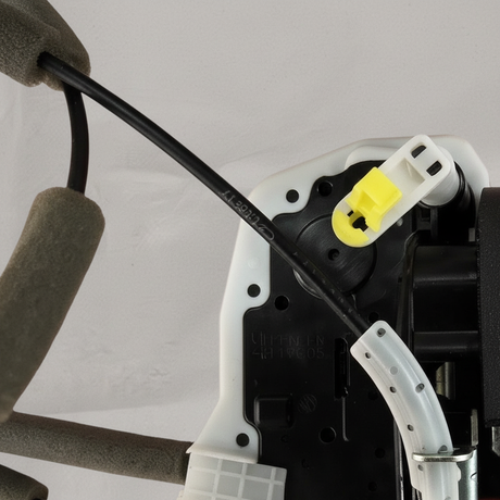 Top macro crop of door lock actuator motor on light grey wrinkled kraft paper