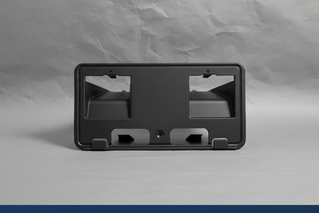 2023-2025 Ford F350 F450 Dually Front License Plate Bracket OEM - Rotated 27 degrees on gray kraft paper background