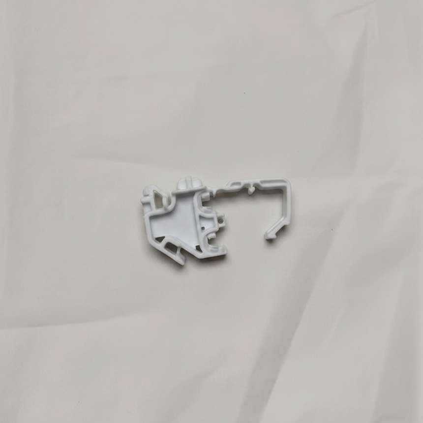 Full view of torsion spring clip on light grey wrinkled kraft paper background