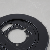 Brake backing plate top section macro crop on light grey wrinkled kraft paper background