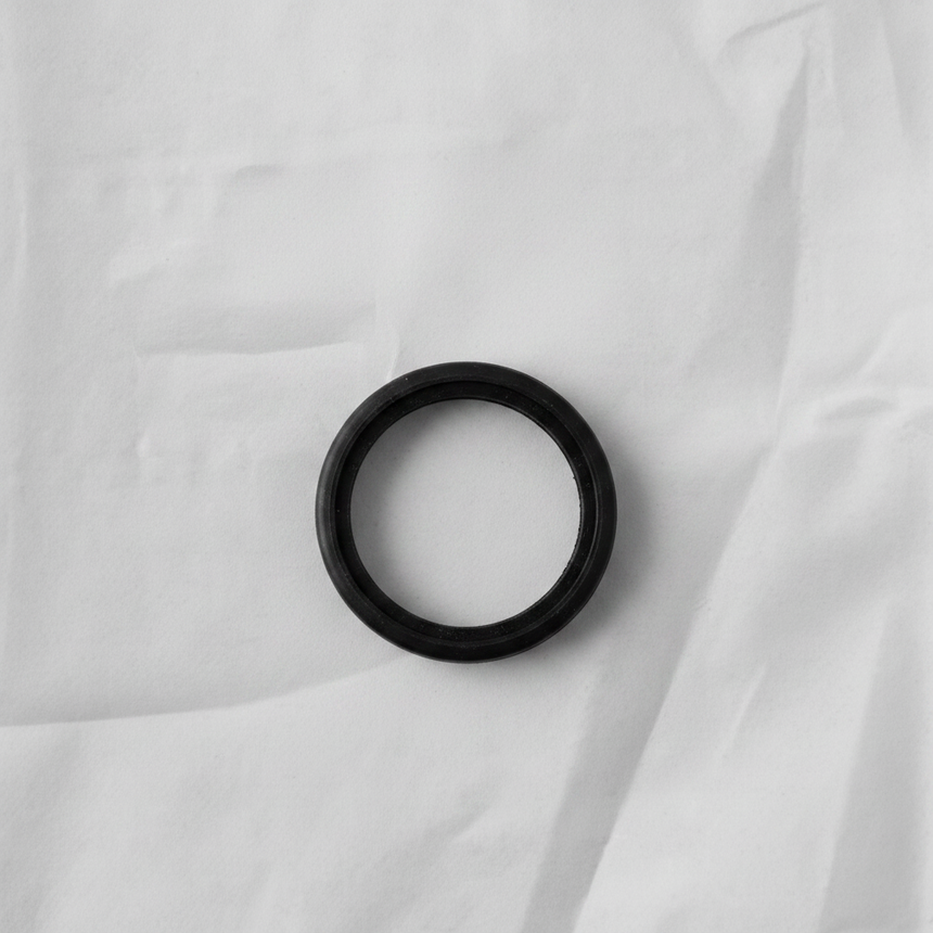 Transfer case input shaft seal on grey wrinkled kraft paper background
