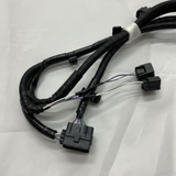 Bottom macro crop of rear park assist camera wiring harness on light grey wrinkled kraft paper