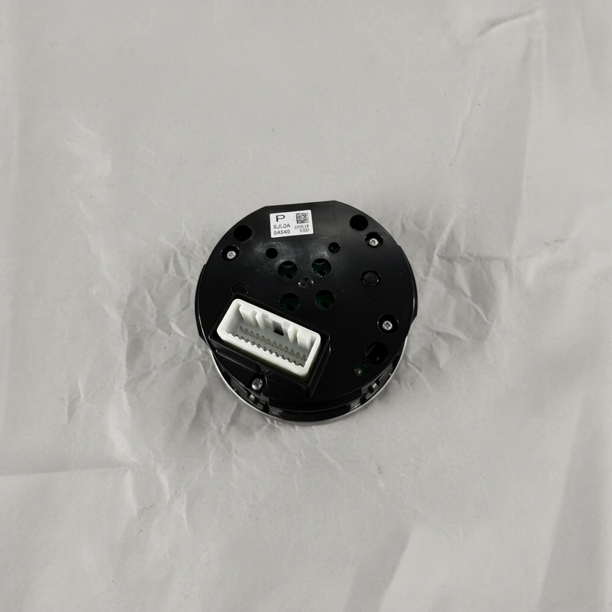 Full view of center control switch AWD angle 2 on light grey wrinkled kraft paper