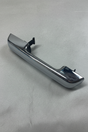 Chrome passenger-side door handle on grey wrinkled craft paper