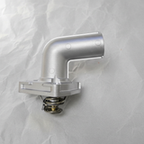 2001-2010 Nissan Altima Maxima Murano Quest 3.5L Thermostat OEM on grey wrinkled craft paper