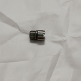 Oil filter stud on grey wrinkled kraft paper background