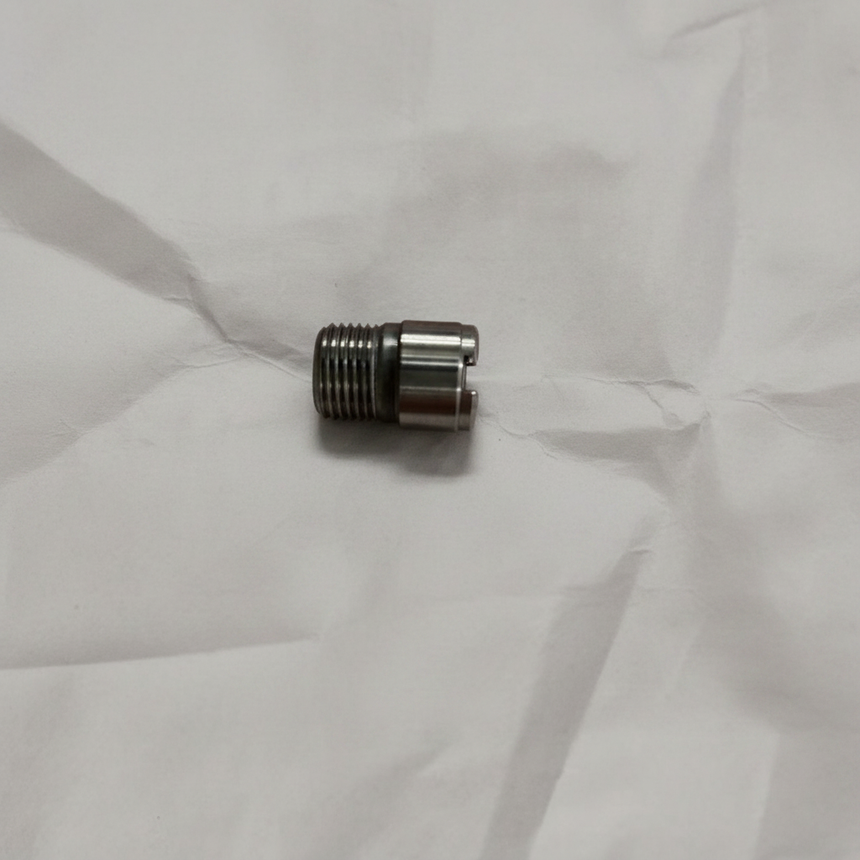 Oil filter stud on grey wrinkled kraft paper background