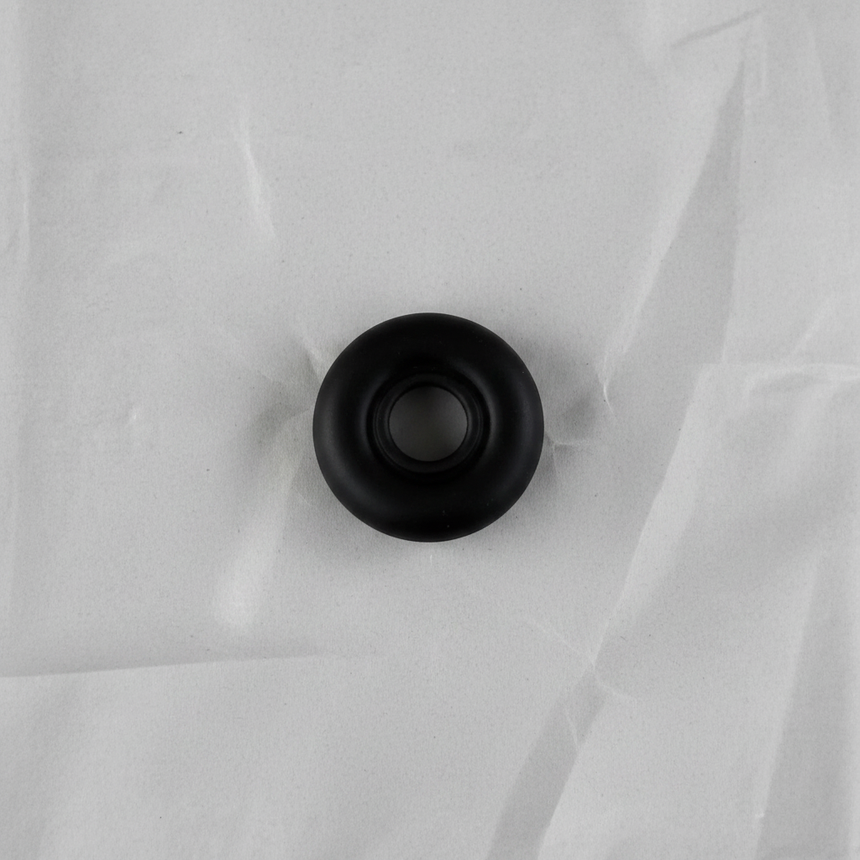 Full view of rear wiper motor seal angle 2 on light grey wrinkled kraft paper