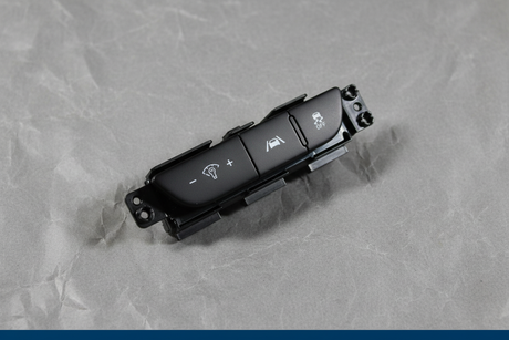 2022-2024 Kia Carnival Dashboard Switch Panel Genuine OEM - Rotated 27 degrees on gray kraft paper background