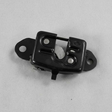Upper-middle macro crop of rear gate latch on light grey wrinkled kraft paper