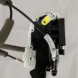 Upper-middle macro crop of door lock actuator motor on light grey wrinkled kraft paper