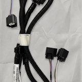 Lower-middle macro crop of rear park assist camera wiring harness on light grey wrinkled kraft paper