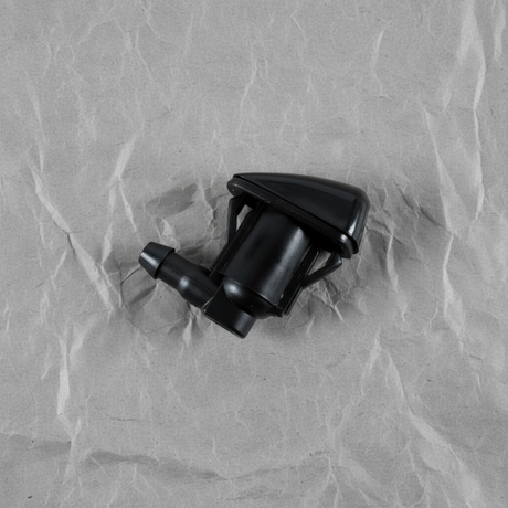 2005-2015 Toyota Tacoma Windshield Washer Nozzle OEM - rotated 30 degrees on kraft paper background