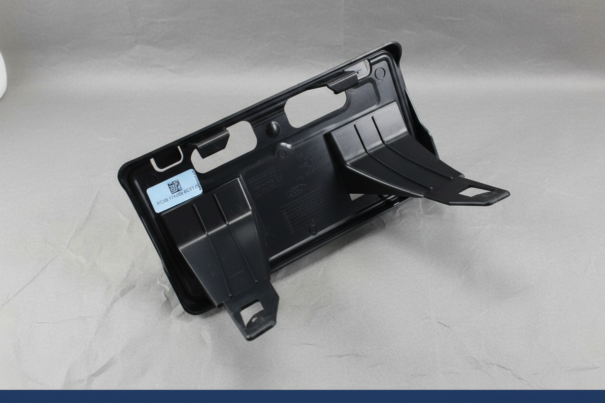2023-2025 Ford F350 F450 Dually Front License Plate Bracket OEM - Mounting view on gray kraft paper