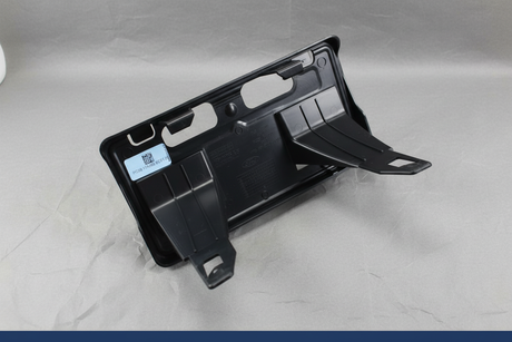 2023-2025 Ford F350 F450 Dually Front License Plate Bracket OEM - Mounting view on gray kraft paper