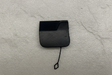 2021-25 Silverado Tahoe Escalade Rear Bumper Tow Eye Cap OEM on grey kraft paper background