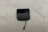 2021-25 Silverado Tahoe Escalade Rear Bumper Tow Eye Cap OEM on grey kraft paper background