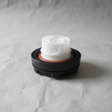 Mazda OEM fuel tank gas cap interior view on grey kraft paper