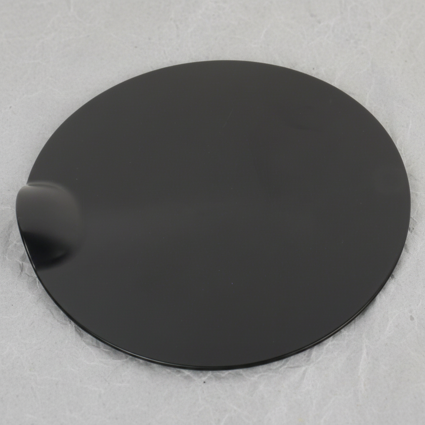 Middle macro crop of Ford F-150 fuel tank filler door on light grey wrinkled kraft paper