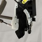 Bottom macro crop of door lock actuator motor on light grey wrinkled kraft paper
