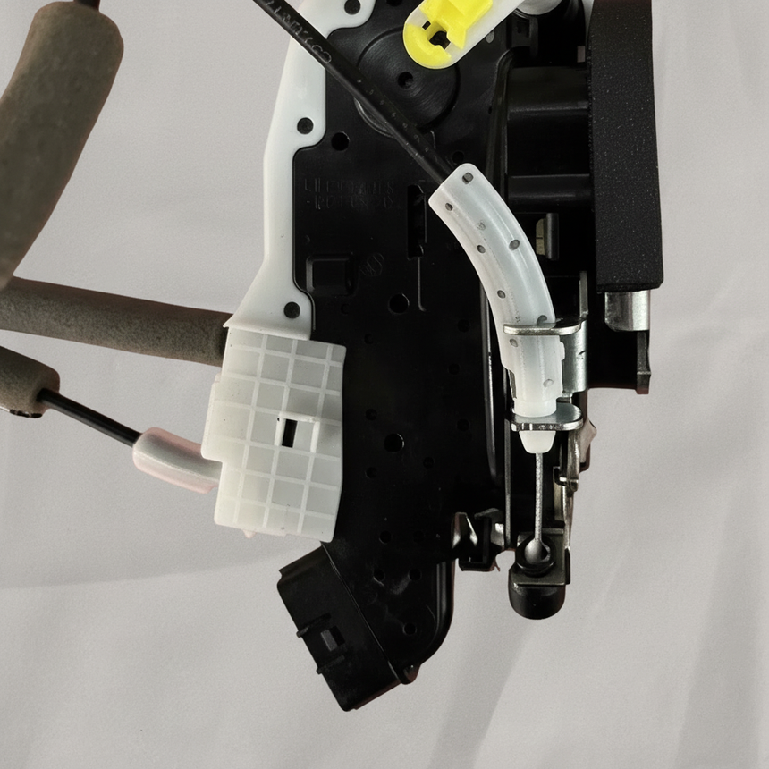 Bottom macro crop of door lock actuator motor on light grey wrinkled kraft paper
