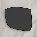 Top macro crop of driver side mirror glass on light grey wrinkled kraft paper