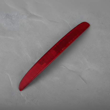 2017-2021 Honda Civic OEM Driver Side Rear Reflector Hatchback - rotated 30 degrees on kraft paper background