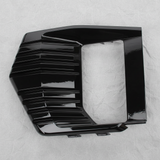 Full view of GMC Yukon fog light lamp bezel trim on light grey wrinkled kraft paper