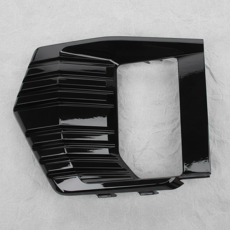 Full view of GMC Yukon fog light lamp bezel trim on light grey wrinkled kraft paper