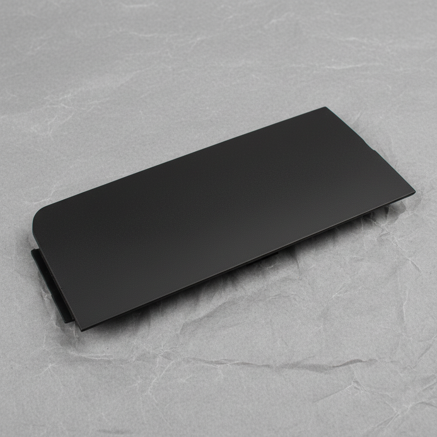 Close-up of GM OEM Black Unpainted Front Bumper Tow Eye Access Hole Cover
