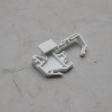 Top macro crop of torsion spring clip on light grey wrinkled kraft paper background