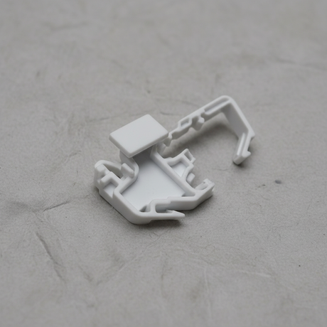 Top macro crop of torsion spring clip on light grey wrinkled kraft paper background